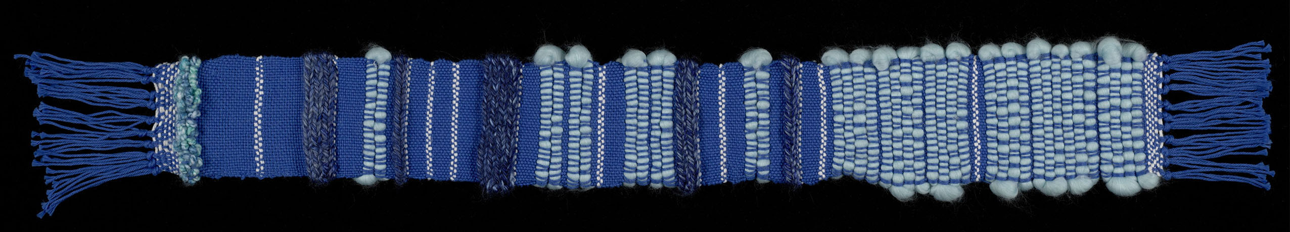 A blue scarf-like weaving with alternating bands of varied threads.